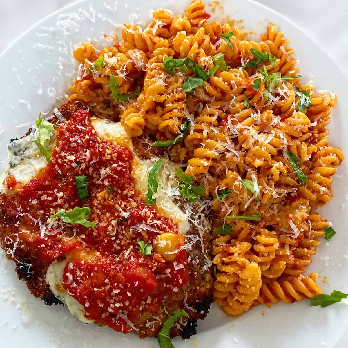https://evseats.com/wp-content/uploads/2022/10/chicken-parmesan-spicy-fusilli-pasta-2-scaled.jpg